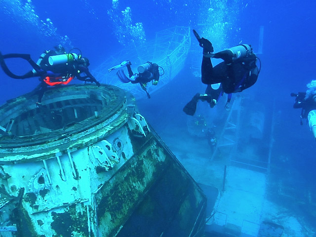Divers explore the superstructure of the Gen. Hoyt S. Vandenberg artificial reef in the Florida Keys National Marine Sanctuary off Key West, Fla., Friday, May 29, 2009. After a dramatic May 27 scuttling, the Vandenberg opened to the public Saturday, May 30. The Vandenberg's hull rests on the sandy bottom in about 145 feet of water, but the 523-foot-long former U.S. Air Force missile tracking ship is so massive that its superstructure begins just 45 feet below the sea surface. (Haig Jacobs/Florida Keys News Bureau/HO)