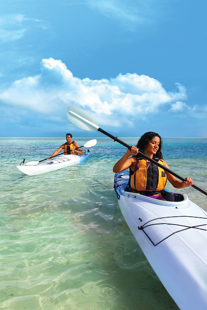 A man and a woman ocean kayaking