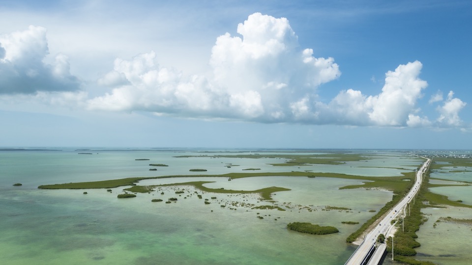 Aerial view of the Overseas Highway, the ocean, islands, and clouds