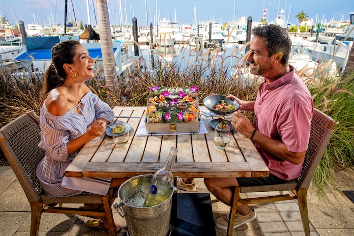 A couple eating on a restaurant patio in the Lower Keys