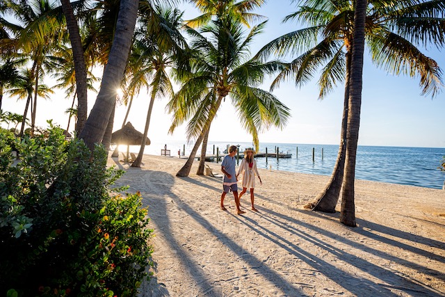 A couple holding hands on a beach in the Florida Keys