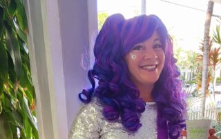 Nadine Grossman Orr with a purple wig and face glitter during Fantasy Fest in Key West