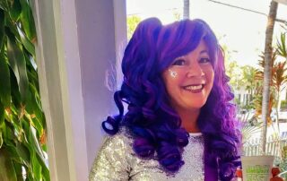Nadine Grossman Orr with a purple wig and face glitter during Fantasy Fest in Key West