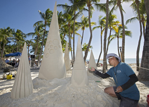 Singapore artist Joo Heng Tan wields his hand tools with gentle, precise strokes to embellish his abstract sand sculpture, titled "The Drop." (All photos by Rob O'Neal, Florida Keys News Bureau)