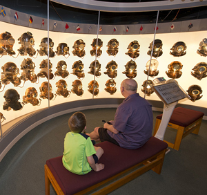 Jack Samples (left) and J.R. Samples listen to narration showcasing 45 historical dive helmets from 24 countries at the History of Diving Museum in Islamorada. (Photo by Andy Newman, Florida Keys News Bureau)
