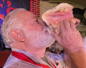 Hemingway Look-Alike blowing conch shell Key West