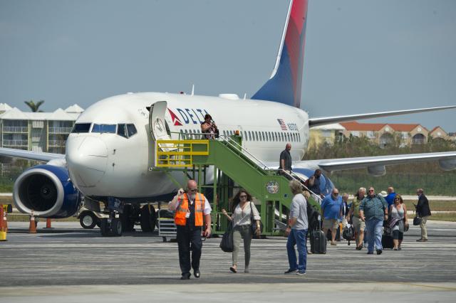 Delta flight passengers at Key West International Airport Wednesday, Sept. 20, on the first commercial airline arrival since flights were suspended prior to Hurricane Irma. Image: Rob O'Neal
