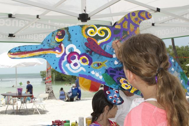 Kids can have their own fun by painting a life-sized dolphin statue.