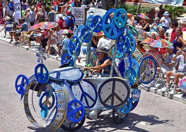 A creative parade veteran, Virginia Wark pedals her Peace Trike entry. 