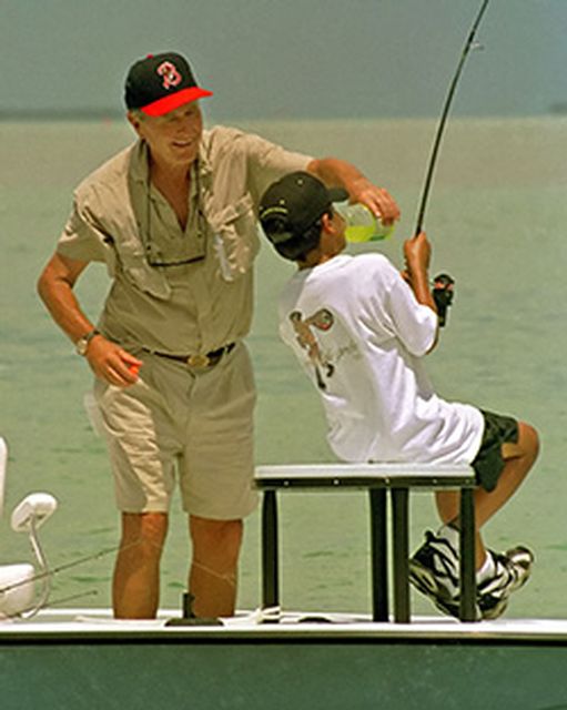  The nation’s 41st president, George Bush, pictured here providing some welcome liquid refreshment to grandson Jeb Bush during a past Keys tournament, was an avid Florida Keys angler. Image: Andy Newman