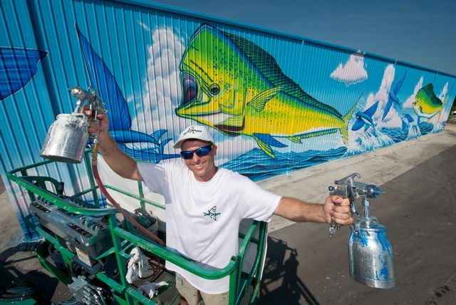 Islamorada’s outdoor canvases include ‘Dolphin Rodeo,’ a giant mural by sea life artist David Dunleavy on the sides of two metal boat storage barns. 