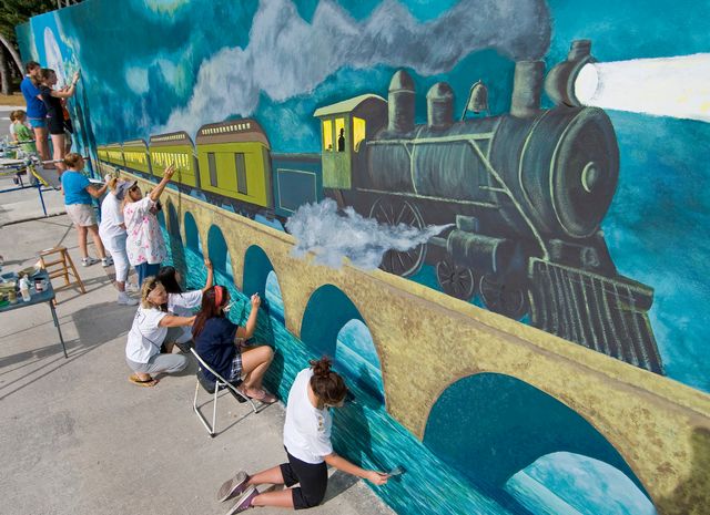 Art students place final touches on the Flagler mural to commemorate the railroad's 100th anniversary in 2012. 