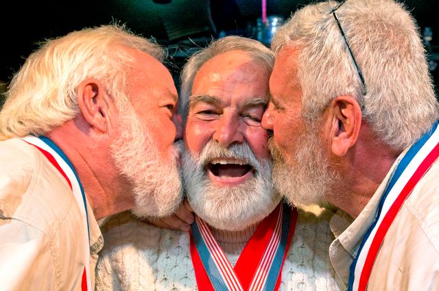 Richard Filip, center, gets congratulatory smooches from Charlie Boice, left, and Dave Hemingway, right, after winning the 2017 Hemingway Look-Alike Contest.