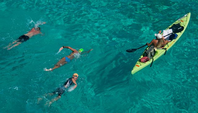 Each swimmer is accompanied by a safety kayaker. 