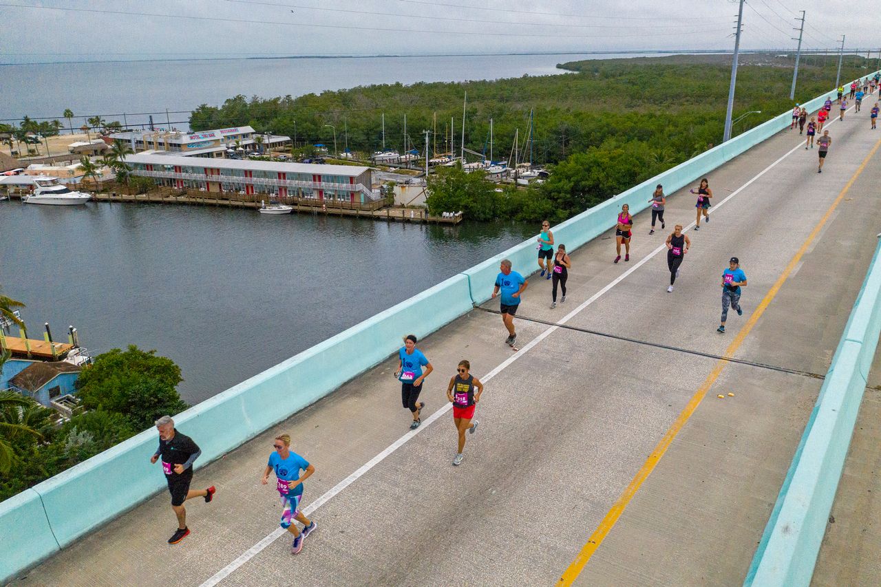 Runners traverse the panoramic 65-foot-high Jewfish Creek Bridge — considered the entryway to the Florida Keys — part of the Florida Keys Overseas Highway that connects mainland South Florida to Key Largo.