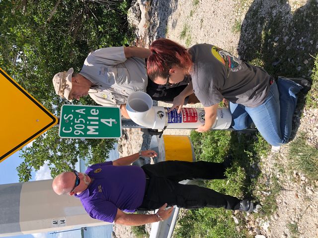 Budnik with Islamorada fire chief Terry Abel and Rotarian Frank Derfler installing a monofilament line recycling bin. 
