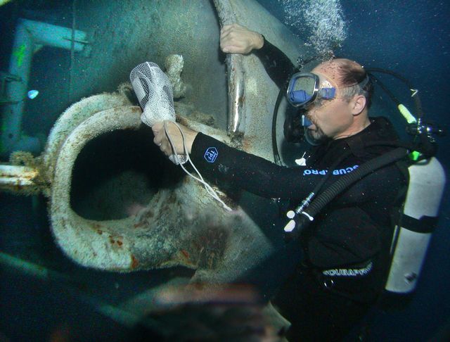 Jim Lupino, then vice-chairman of the Key Largo Chamber of Commerce, smacks a bottle of champagne against Spiegel Grove June 26, 2002, to officially dedicate the new artificial reef. Image: Bob Care
