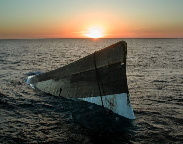 The sun sets over the upside-down hull of the Spiegel Grove, shot May 17, 2002. Spiegel was to be scuttled upright. Image: Andy Newman