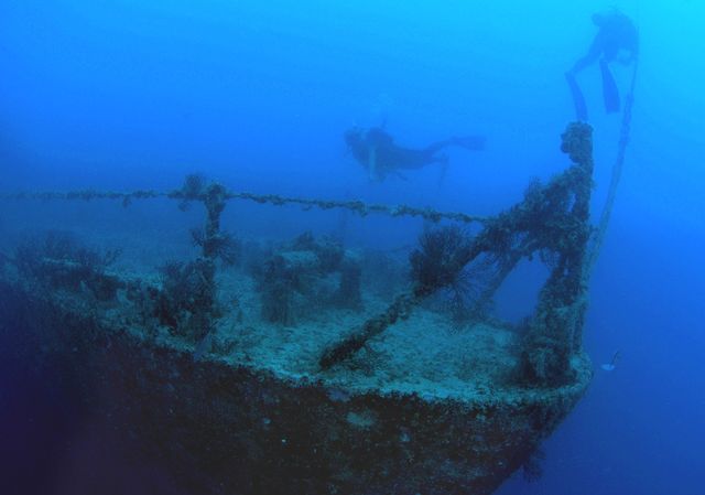 Divers swim on Spiegel Grove July 12, 2005. Since it was fully sunk June 10, 2002, the ship had rested on its starboard side. But July 11, 2005, divers discovered the ship had rolled upright.