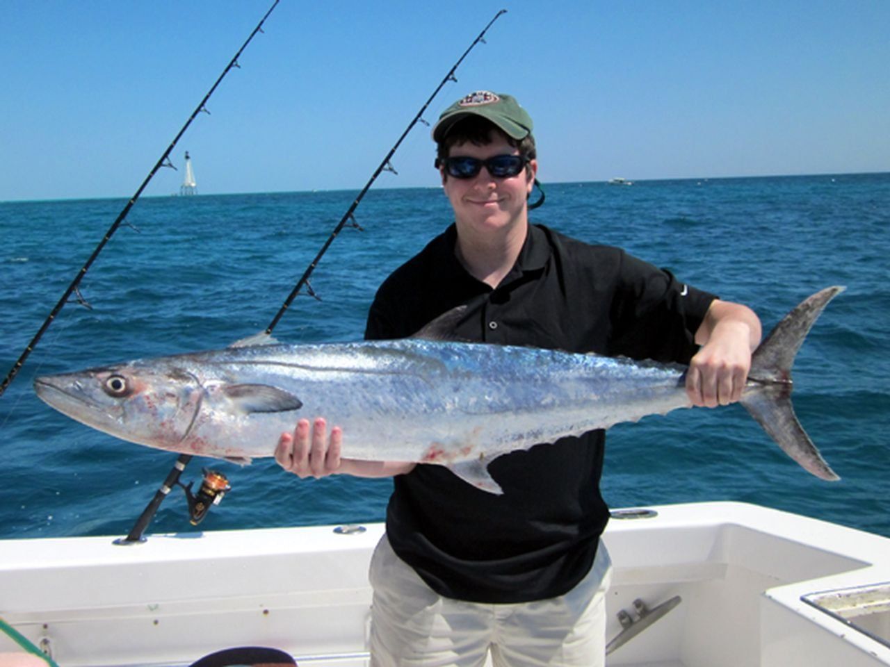 A participant displays a king mackerel caught during the months-long Key West Fishing Tournament.