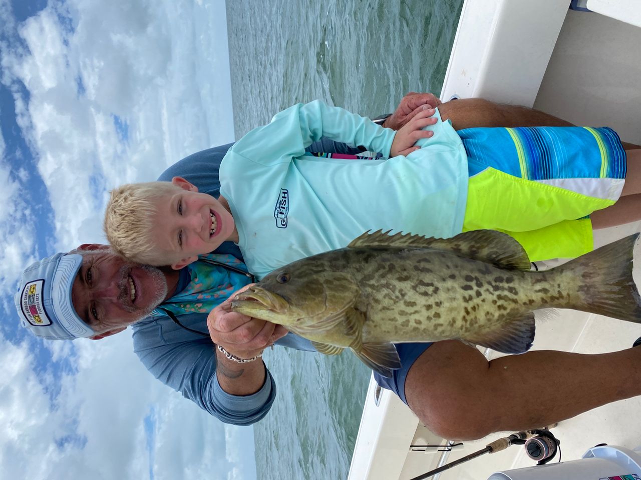 Captain Matt Bellinger celebrates his young fishing client's big catch. 
