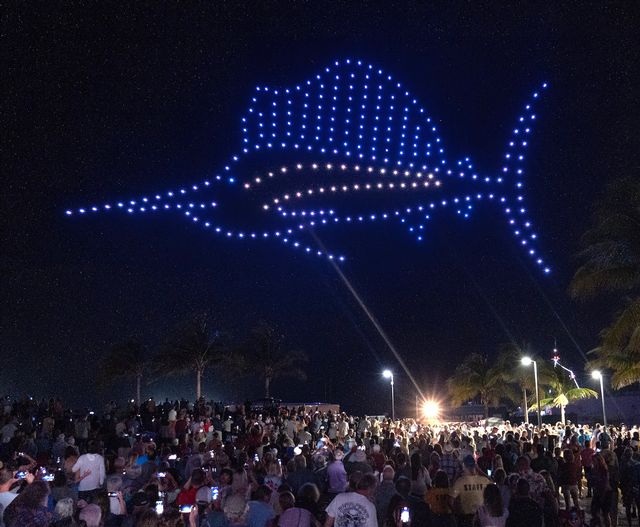 Spectators view a sailfish image formed by 250 drones over Key West during the drone show that capped the bicentennial’s kick-off concert. Photo by Rob O’Neal.