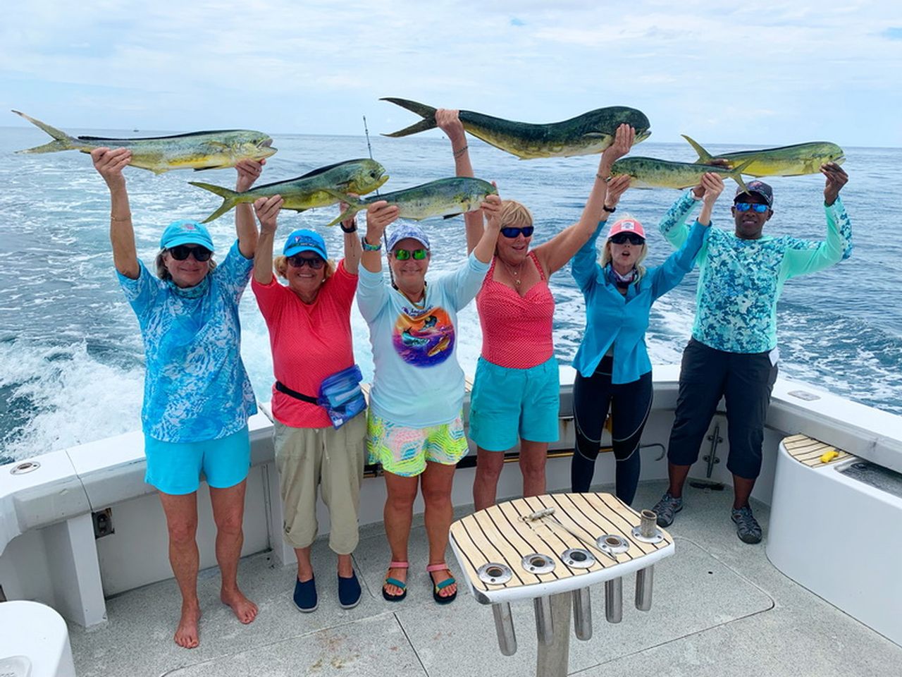Participants in the 2022 LLGF Screaming' Reels tournament hoist their dolphin fish catches aboard the Sea Horse charter boat. Photo courtesy of LLGF.