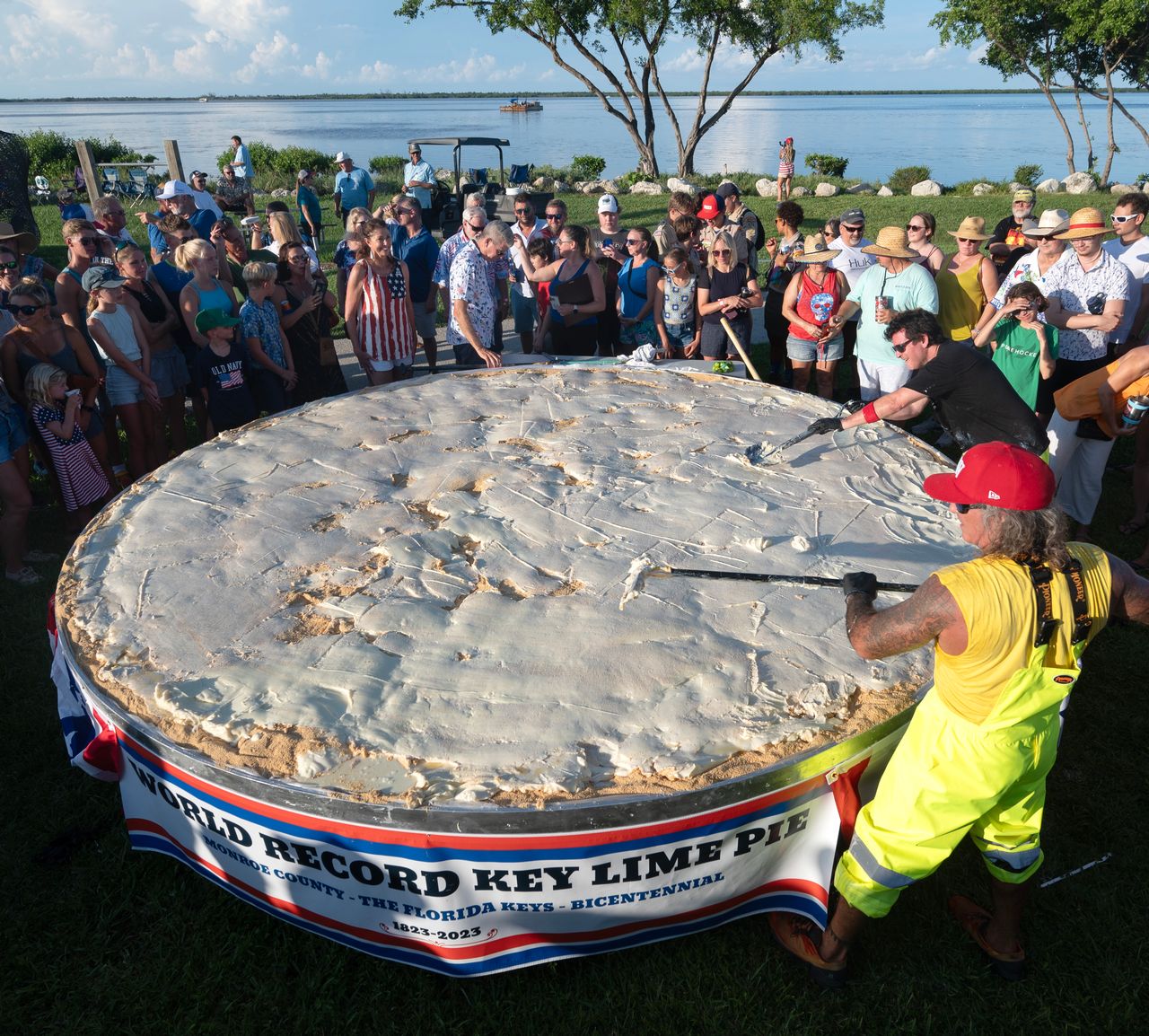 Chefs Paul Menta, front right and David Sloan, back right, put finishing touches on a gargantuan Key lime pie created for a 200th Florida Keys birthday celebration. Photos: Andy Newman