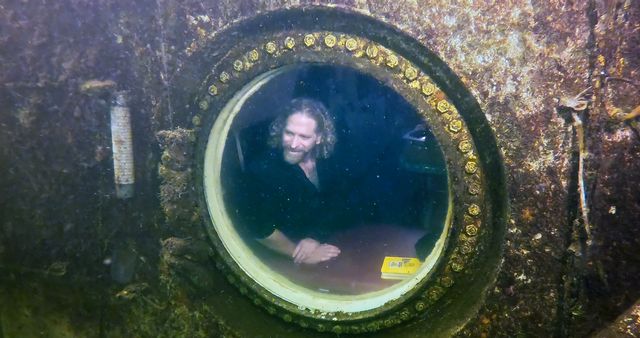 Dituri peers from a porthole inside the Jules' Undersea Lodge, where he spent 100 days conducting marine and medical research and conducting outreach to science and technology-focused students. 