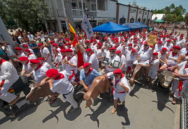 The festival includes Key West's version of Pamplona, Spain's Running of the Bulls, with fake bulls-on-wheels pushed down Duval St. by Hemingway Look-Alike contestants. Photo: Andy Newman