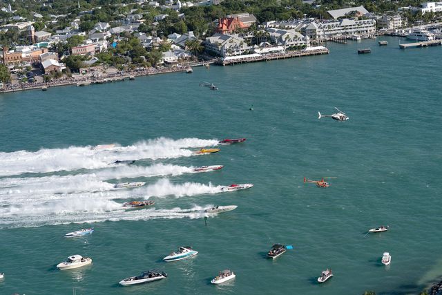 Offshore powerboat race boats cross the start line during the first day of competition in 2022. Photo: Rob O'Neal