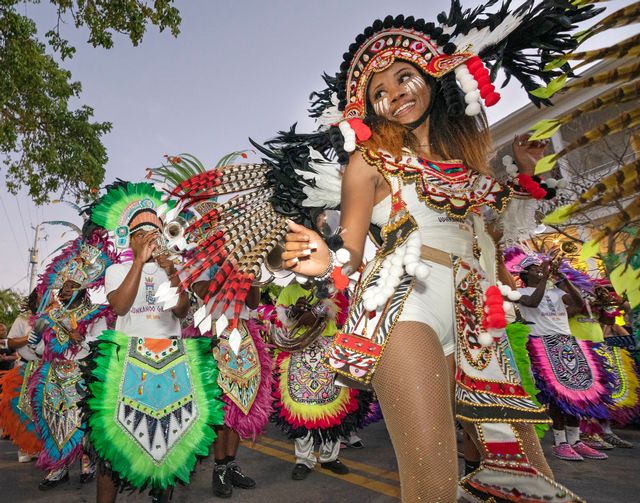 Caribbean-style dancers and musicians march in Bahama Village during the 2022 Junkanoo Parade. Photo: Rob O'Neal