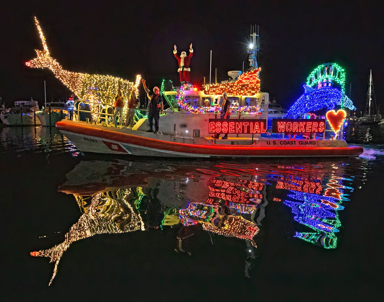 Festively lighted craft of all kinds cruise past Key West Historic Seaport and harbor areas during the annual Schooner Wharf Bar Lighted Boat Parade. Photo: Carol Tedesco