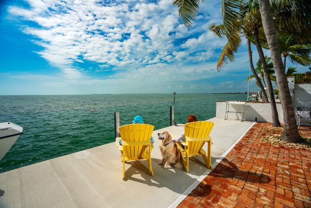 The Livingstons and their dog Anderson enjoying the view from their home on Summerland Key. Photo: Rob O'Neal