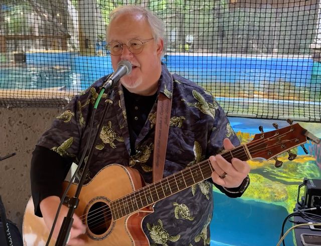 Local Keys musician John Bartus performed a self-penned song about waiting for the mollusk meteorologist. Photo: Bob Care