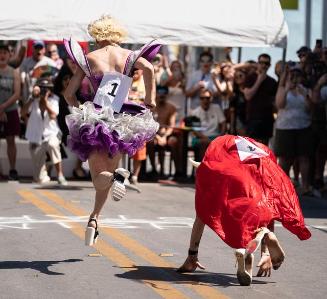 A contestant dressed as a fairy flies to the finish line while another competitor suffers a high-heeled blowout in the annual Drag Race. 