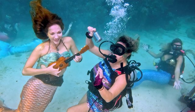 A ukulele-playing mermaid is joined by a sub-sea singer during the Underwater Music Festival at Looe Key Reef in the Florida Keys. 