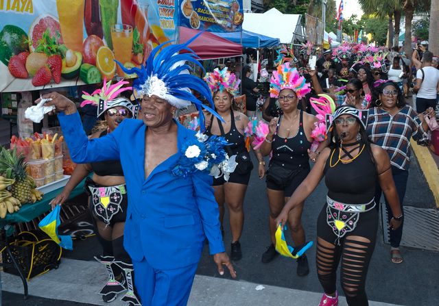 Costumed dancers strut down Petronia Street during the 223 Goombay Festival. 