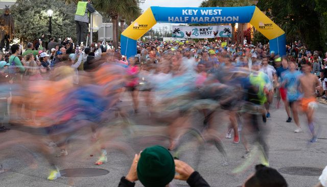 A photographer’s slow shutter speed captures some of the nearly 4,000 participants in a blur as they cross the start line at a previous year's Key West Half Marathon. 