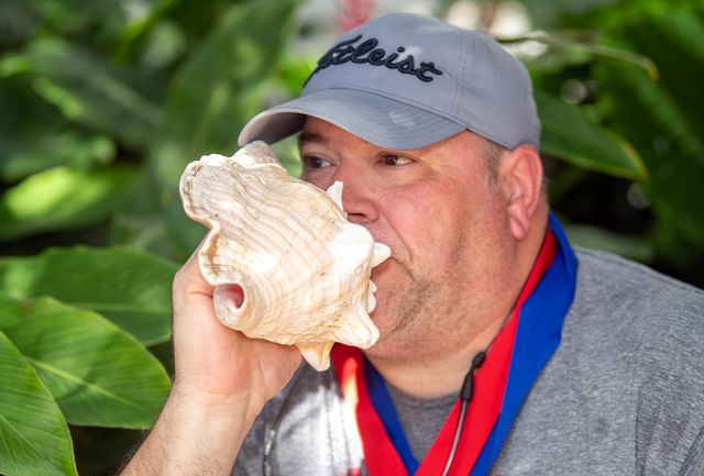 Contestants take turns raising a shell to their lips, endeavoring to make music (or at least respectable sounds) to impress the judging panel and a typically standing-room-only audience. Photo: Mary Martin