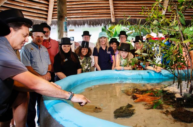 Ben Daughtry with Florida Keys Aquarium Encounters and Marathon, Fla. dignitaries celebrate the mollusk meteorologist's predication. Photo: Chad Newman