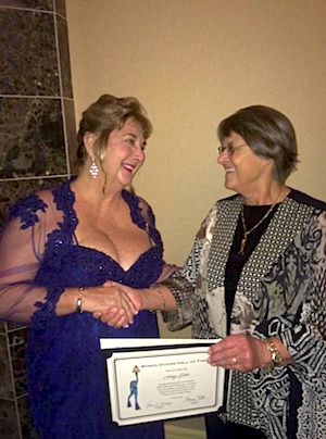 Amy Slate, left, receives her certificate of induction into the Women Divers Hall of Fame in March 2015 from Dr. Sally Bauer.