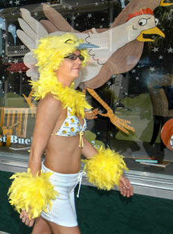 Angelica Rabago of Key West, walks past Fast Buck Freddies during the 2004 ChickenFest Key West street fair.