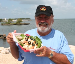 Gary Graves proudly displays a basket of fresh stone crab claws.