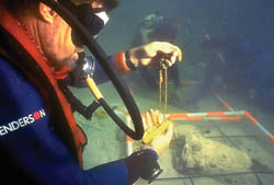 A diver examines gold bars and chains on the site of the Nuestra Señora de Atocha shipwreck. Photo by Pat Clyne/Mel Fisher Museum