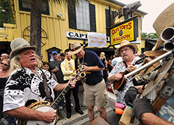 Musicians celebrate the life of "Captain Tony" outside his former bar.