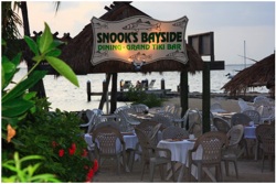 Snook's is an inviting restaurant on the water’s edge with outdoor dining under swaying palm trees, a grand tiki bar complete with tiki torches and a nightly happy hour with live entertainment.