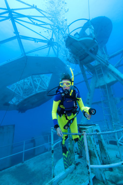Image 4 - Instructor Jaclyn Skafas examines the Vandenberg's superstructure, near one of the wreck's parabolic tracking dishes. Photo by Stephen Frink