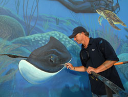 Wyland paints a stingray on the south wall of the Key Largo mural to honor Steve Irwin.